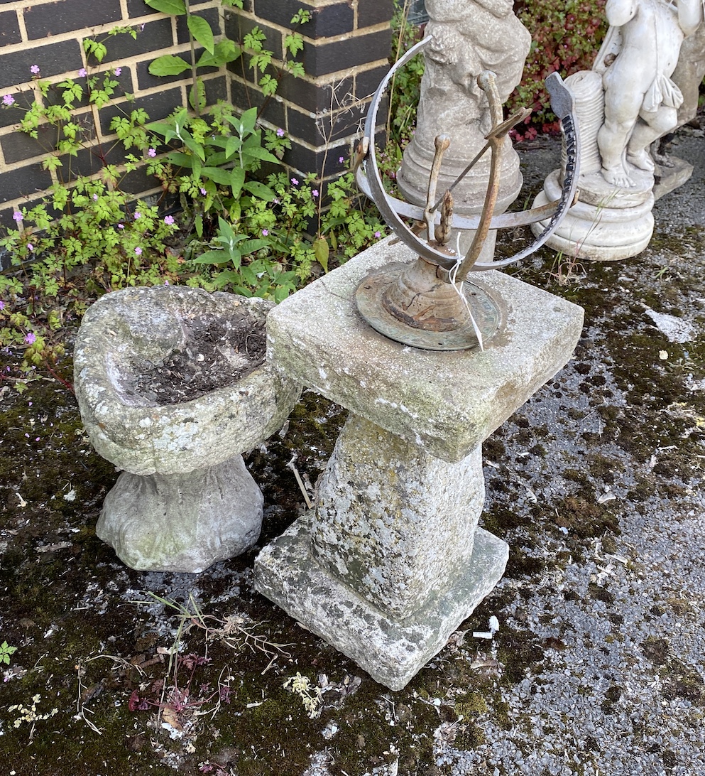 A sphere sundial on reconstituted stone plinth, height 85cm, and a smaller shell shaped bird bath